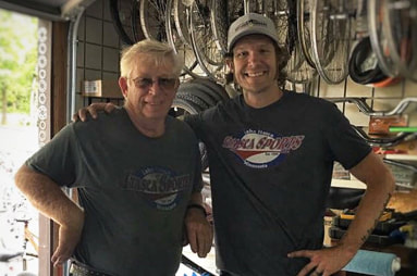 Sam Smith and his dad in the bike repair shop at Itasca Sports